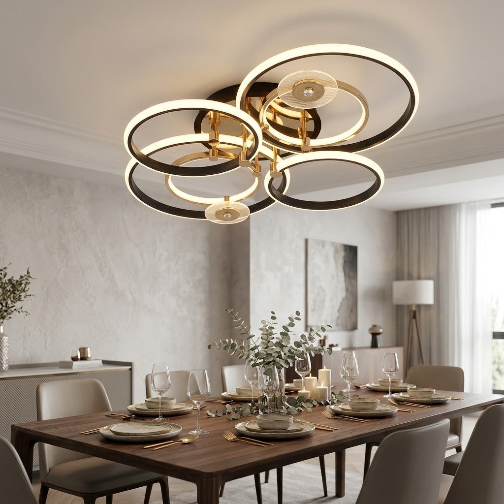 Luxury LED ceiling light with black and gold rings installed above a dining table.