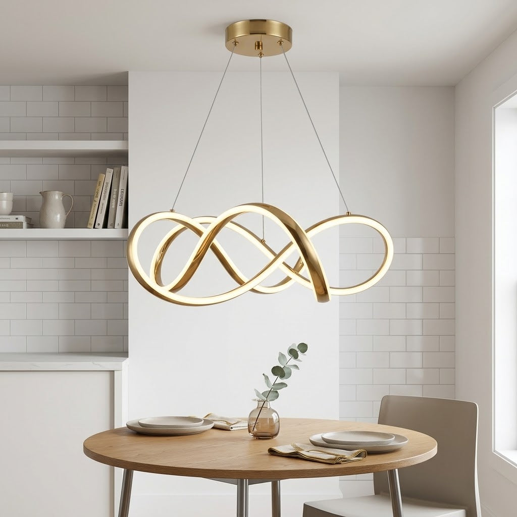Gold LED infinity-loop pendant light installed above a dining table in a kitchen.