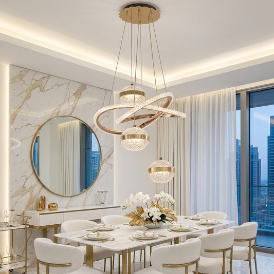 Gold LED multi-drop pendant light with crystal globes installed above a marble dining table.