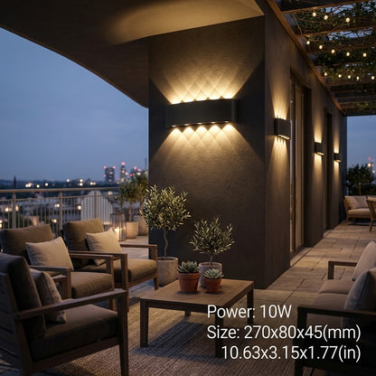 Black LED wall sconce mounted on an exterior wall at night.
