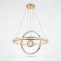 Gold LED orbital ring pendant light with a crystal-effect sphere, shown on a white background.