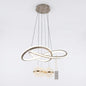 Champagne-finished LED loop pendant light with crystal globes, shown on a white background.