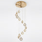 Spiral cascade crystal chandelier in gold with staggered crystal-bubble spheres, shown on a white background.