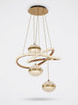 Gold LED multi-drop pendant light with sweeping rings and three crystal-effect globes, shown on a white background.