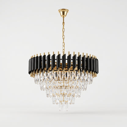 A modern circular chandelier with a gold-tone chain and canopy, black cylindrical rods, and cascading clear crystal prisms, shown against a light gray studio background.