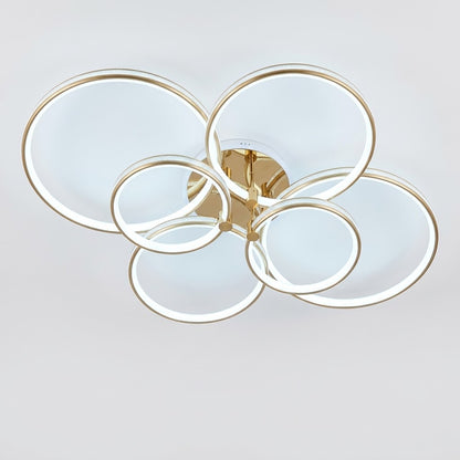 Luxury modern LED ceiling light with interlocking gold rings, shown on a white background.