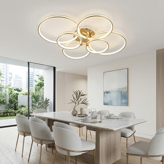 Luxury LED ceiling light with gold interlocking rings installed in a dining room.