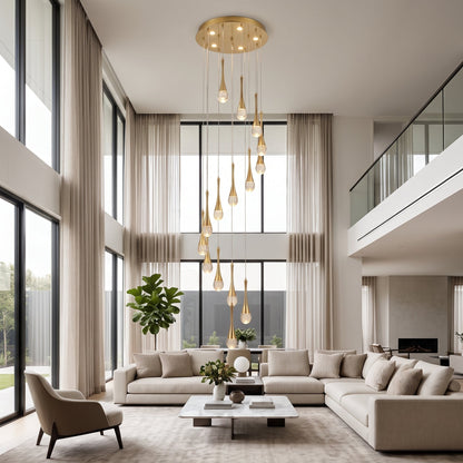 Gold cascading teardrop stair chandelier hanging in a double-height living room