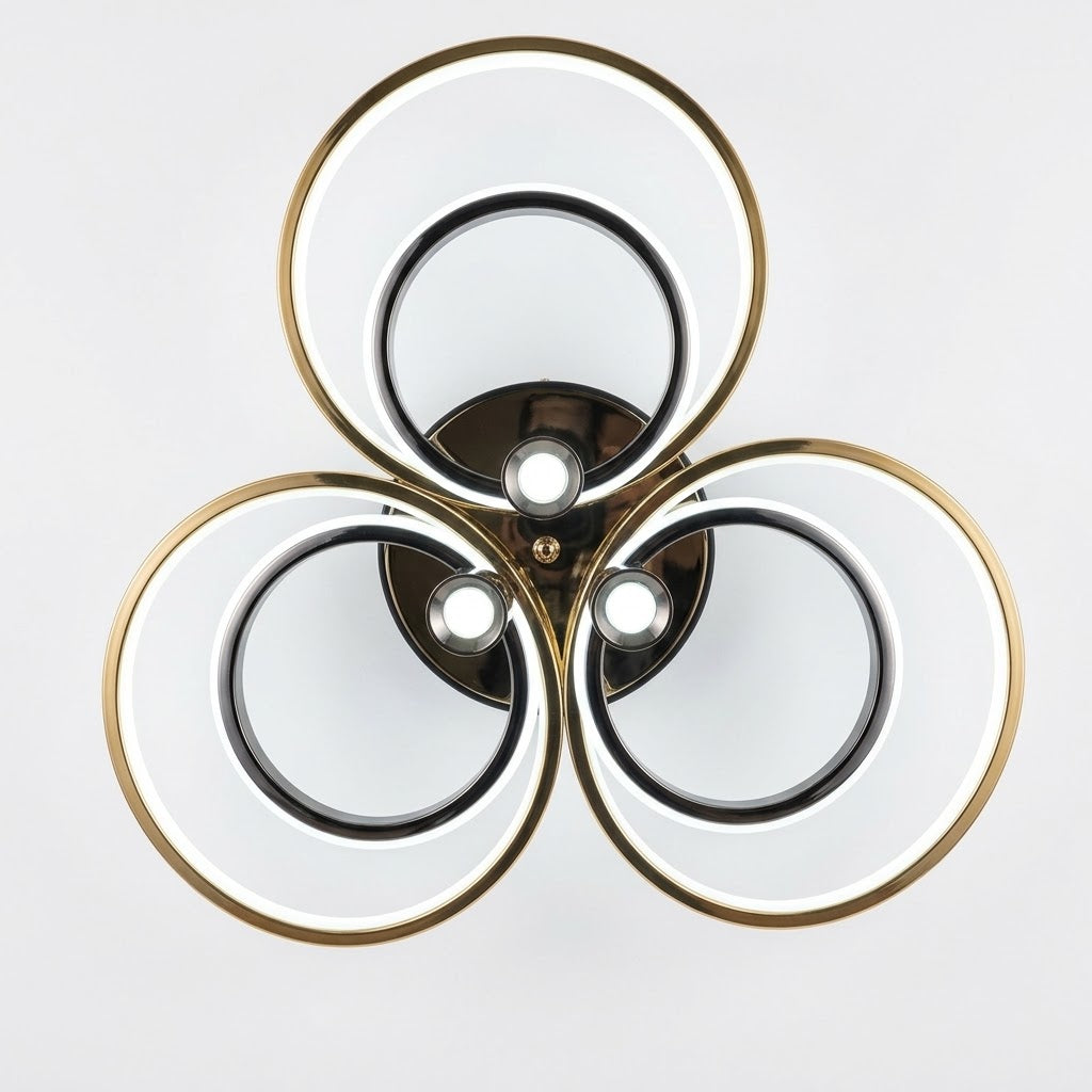 LED triple ring ceiling light in black and gold shown from a front angle.