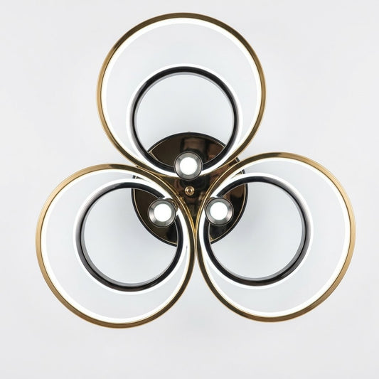 LED triple ring ceiling light in black and gold shown from a front angle.