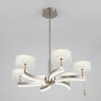 Gold-finished LED pendant chandelier with sculptural curved arms and textured crystal drum shades, shown on a white background.