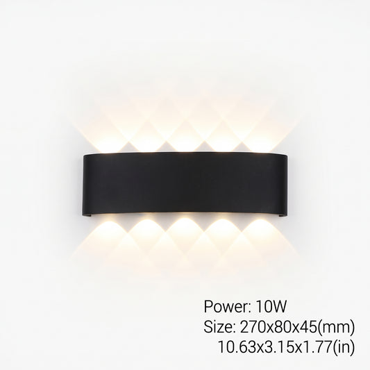 Modern black LED wall sconce installed outdoors, casting upward and downward light on a wall.