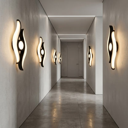 Close-up of the sculptural LED wall light's curved leaf design.