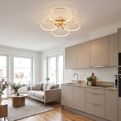 A modern LED ceiling light featuring four interlocking loops in brushed gold with 4 loops.