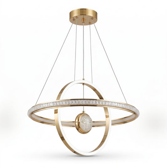 A modern LED pendant light in polished gold, featuring two interlocking illuminated rings arranged around a crystal-textured centre globe.