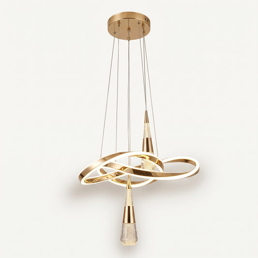 A modern pendant light with a sculptural, flowing gold LED ribbon that loops and twists, with two crystal-bubble teardrop pendants hanging from it. 