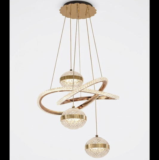 Gold LED multi-drop pendant light with sweeping rings and three crystal-effect globes, shown on a white background.