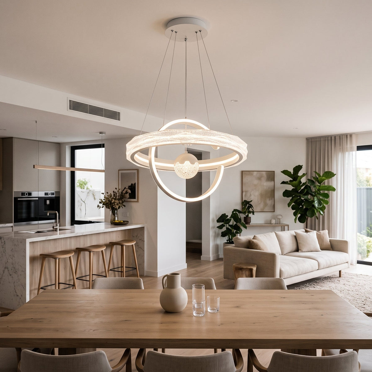 A modern LED pendant light in a soft white finish, featuring a large textured glass-effect ring, flowing LED ribbon curves, and a crystal-textured globe at its centre..
