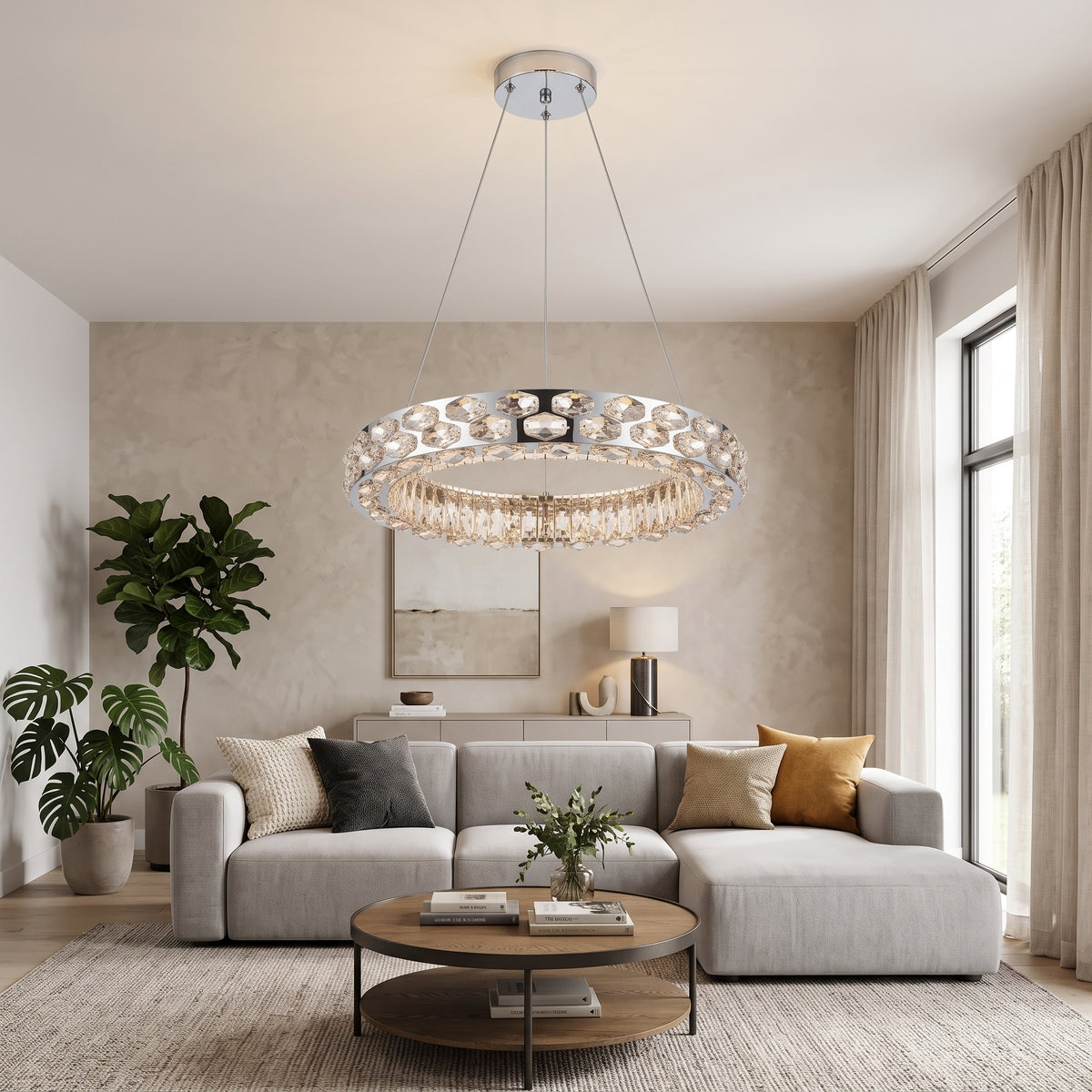 Round gold crystal chandelier hanging in a bright modern living room above a light grey sectional sofa