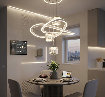 LED loop pendant light with crystal shades installed above a dining table.